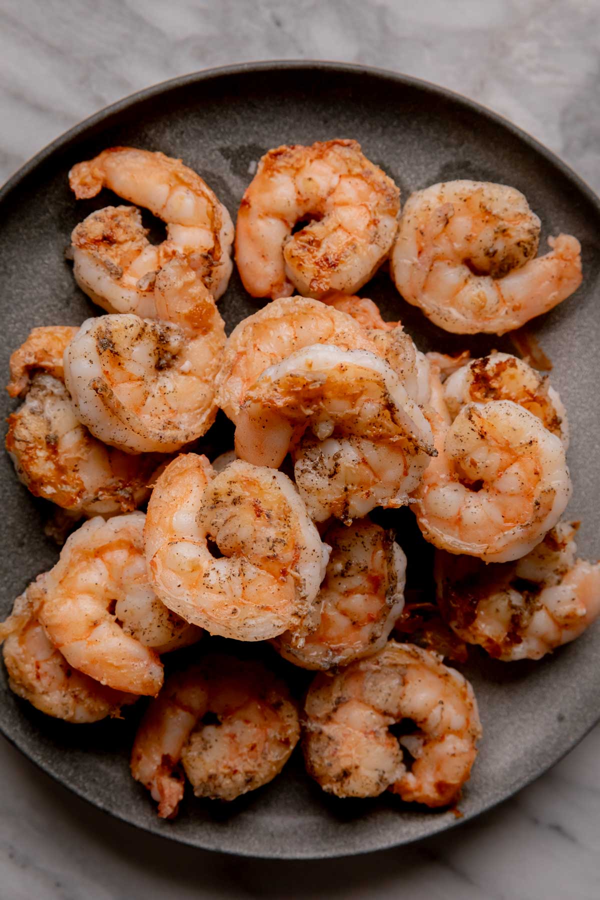 Cooked shrimp on a plate.