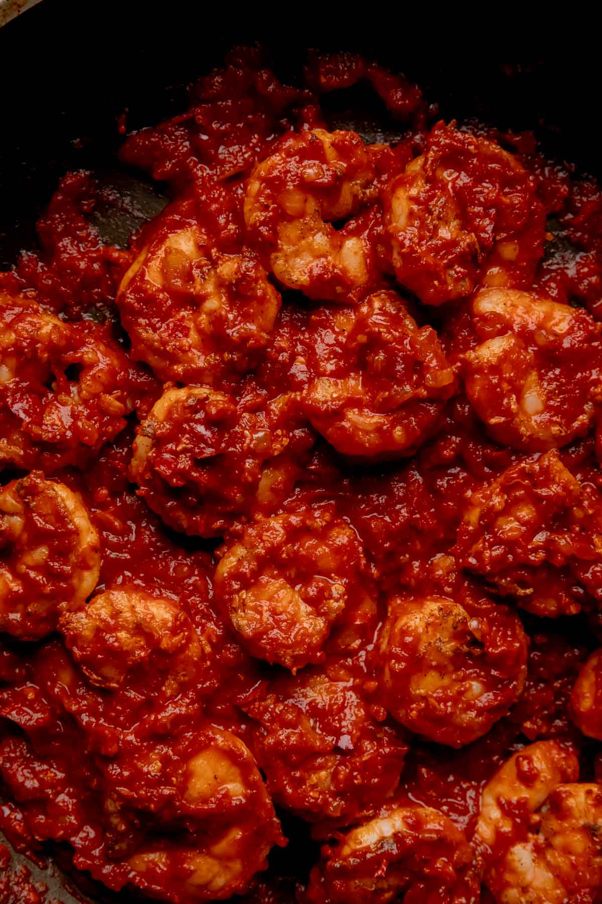 Cooked harissa shrimp in a pan.
