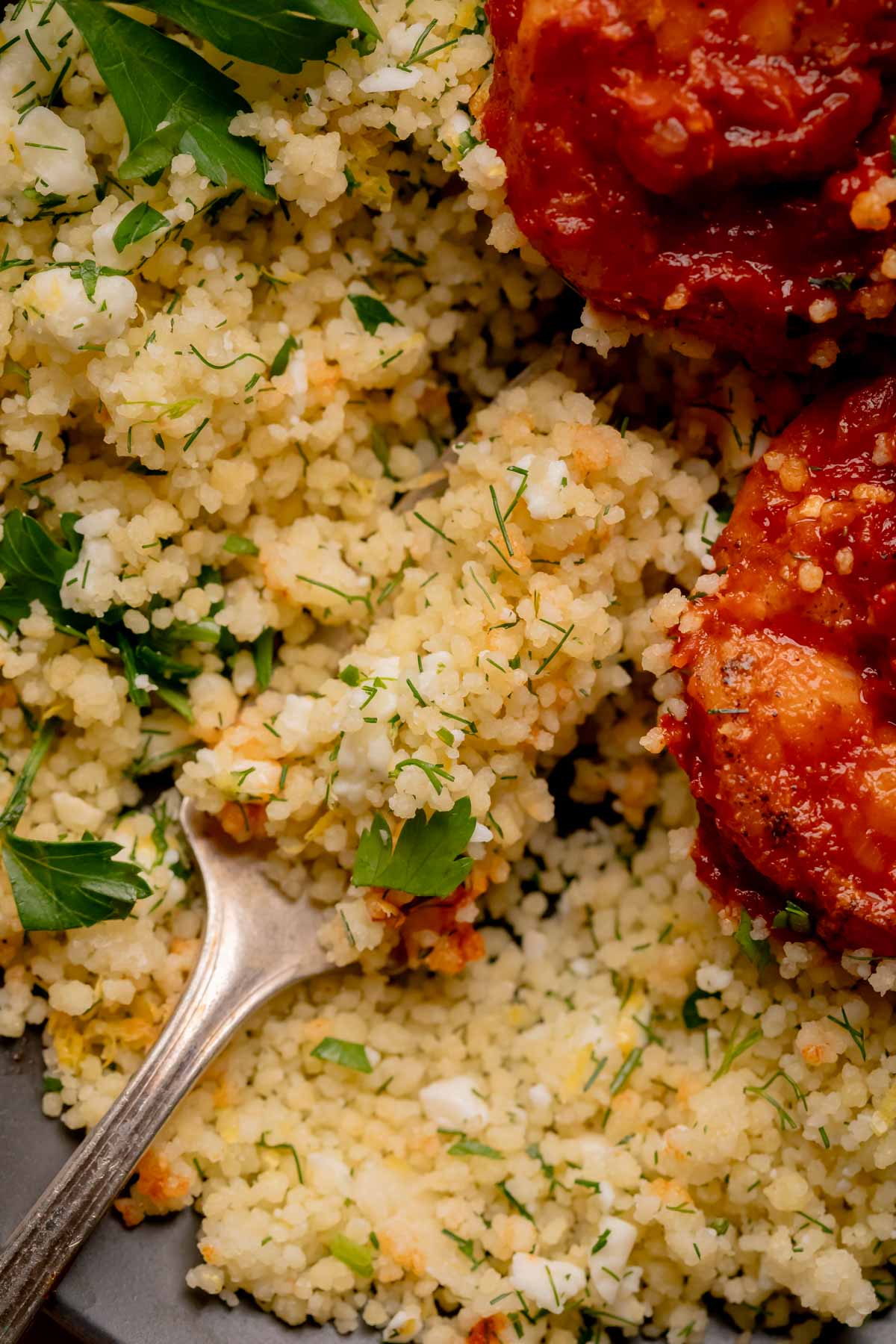 Herbed feta couscous on a fork.