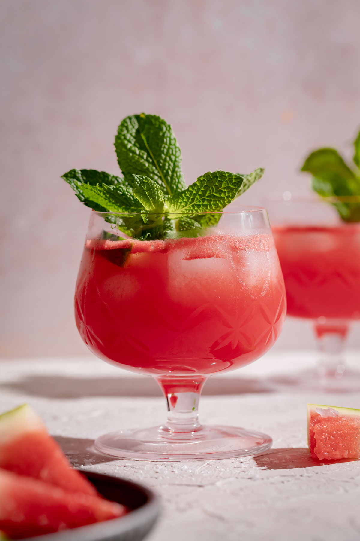 Glasses of salted watermelon juice with a sprig of fresh mint.