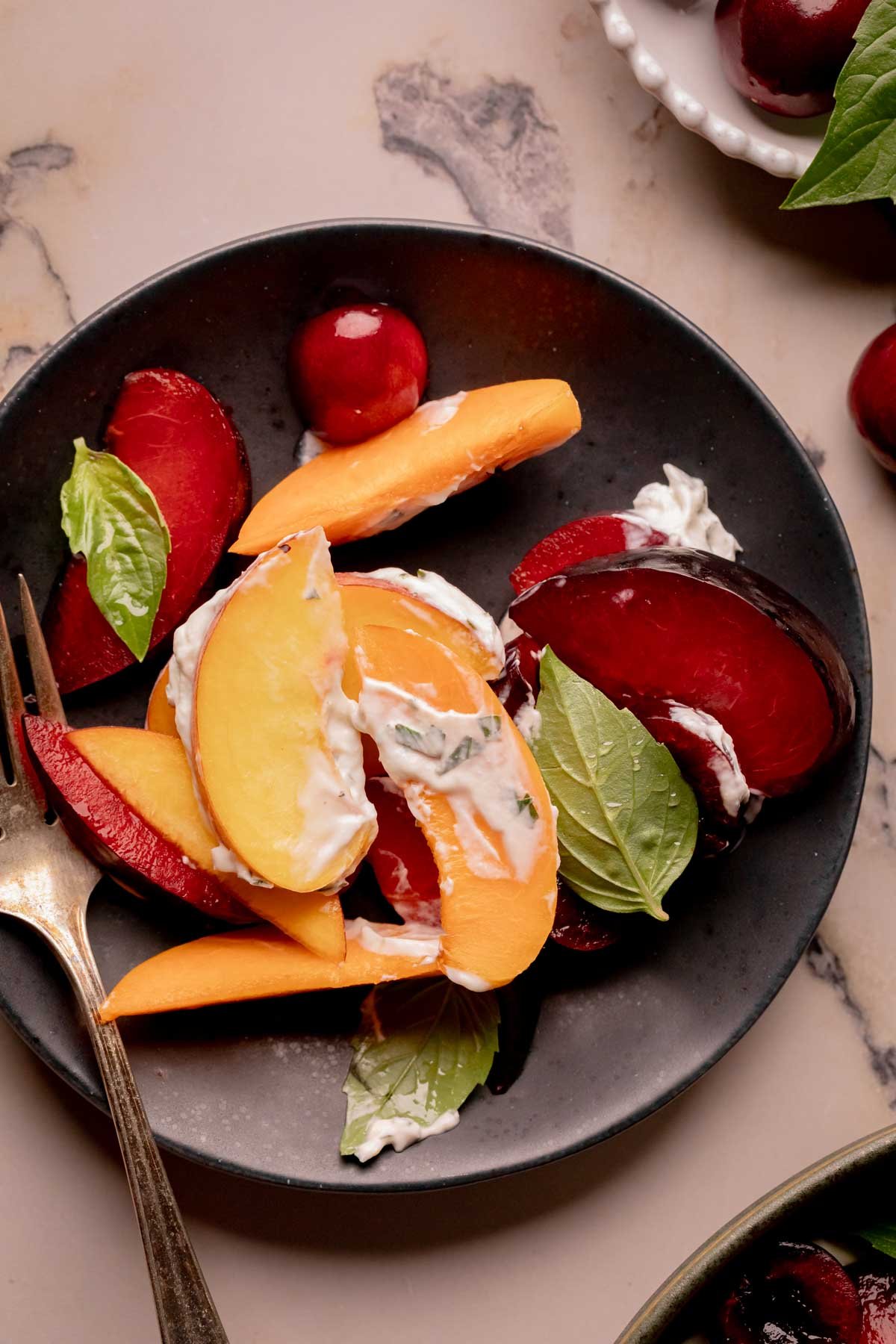Stone fruit salad on a small serving plate.