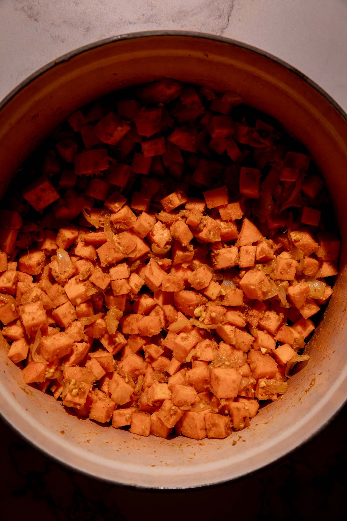 Cubed sweet potatoes in a Dutch oven.