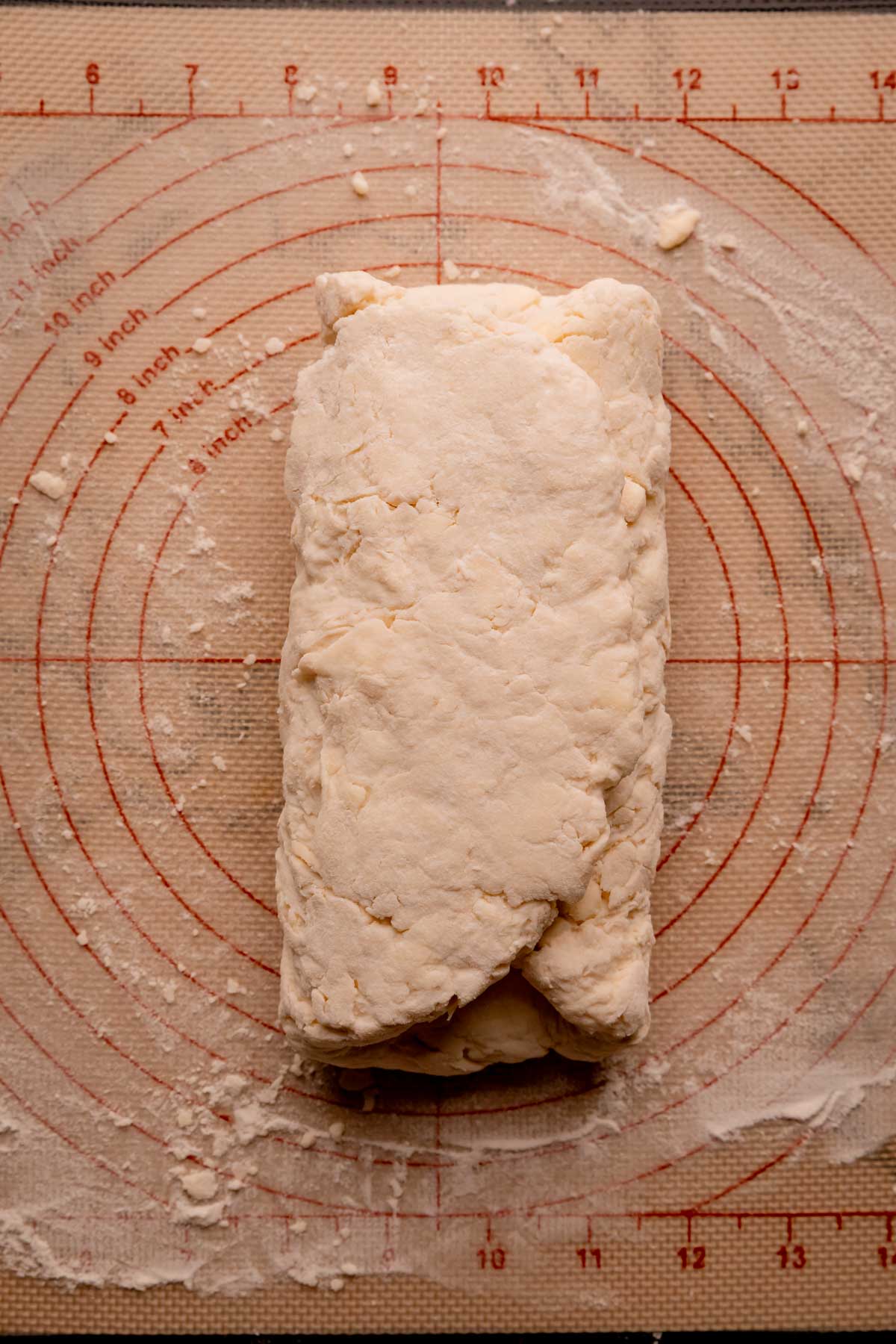 Folded biscuit dough on a silpat.