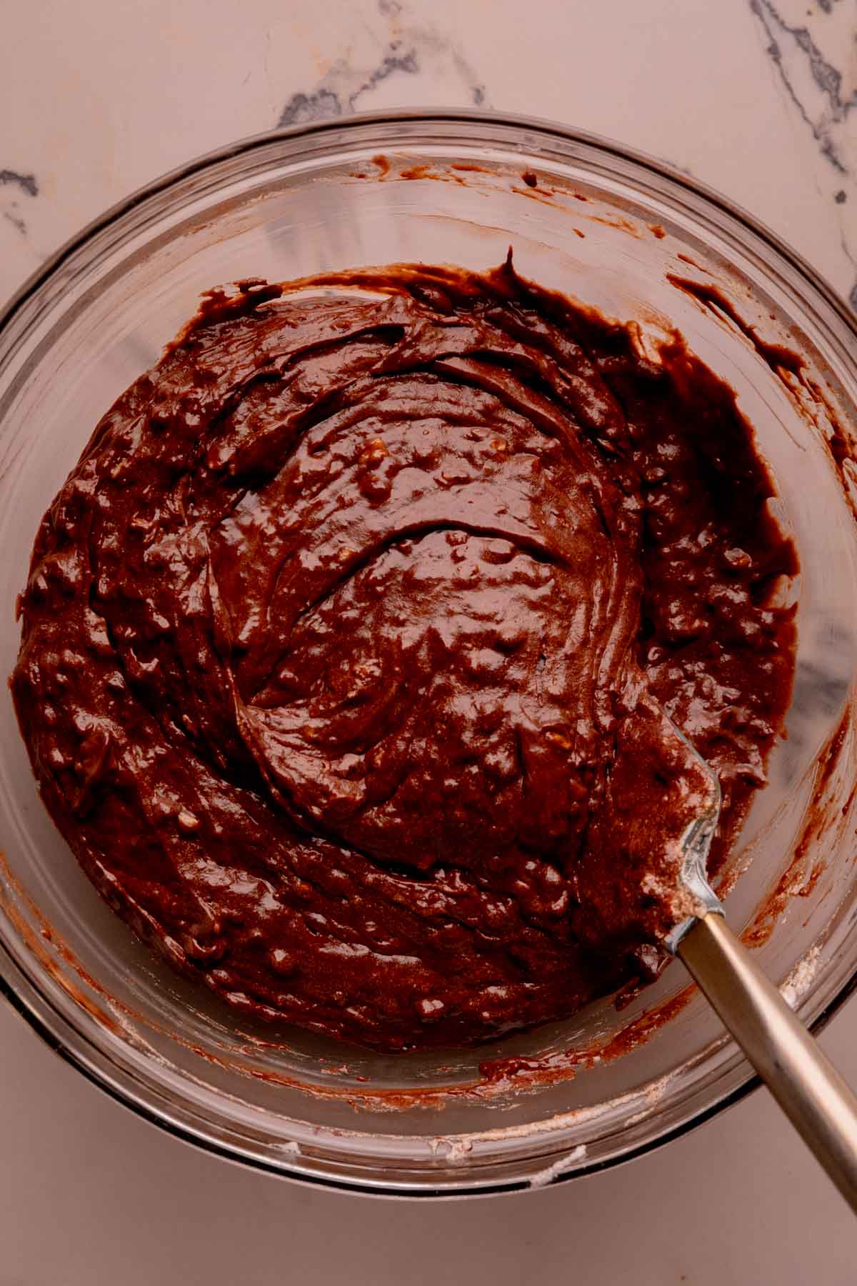A bowl of chocolate cake batter with ground almonds.
