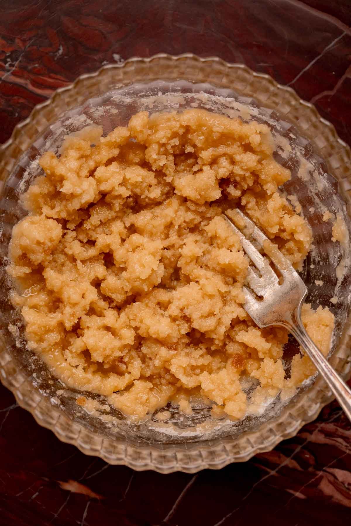 Mixed streusel in a bowl with a fork.