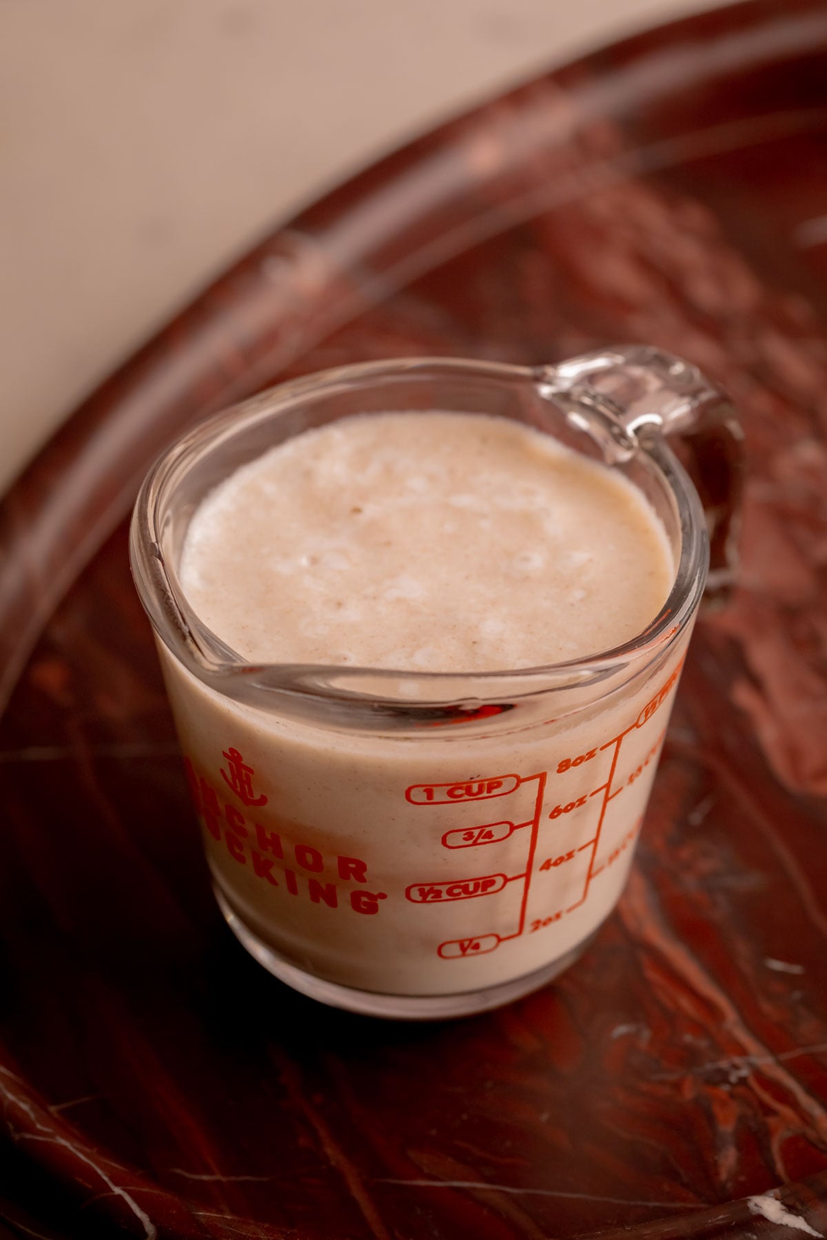 A measuring cup of banana milk.