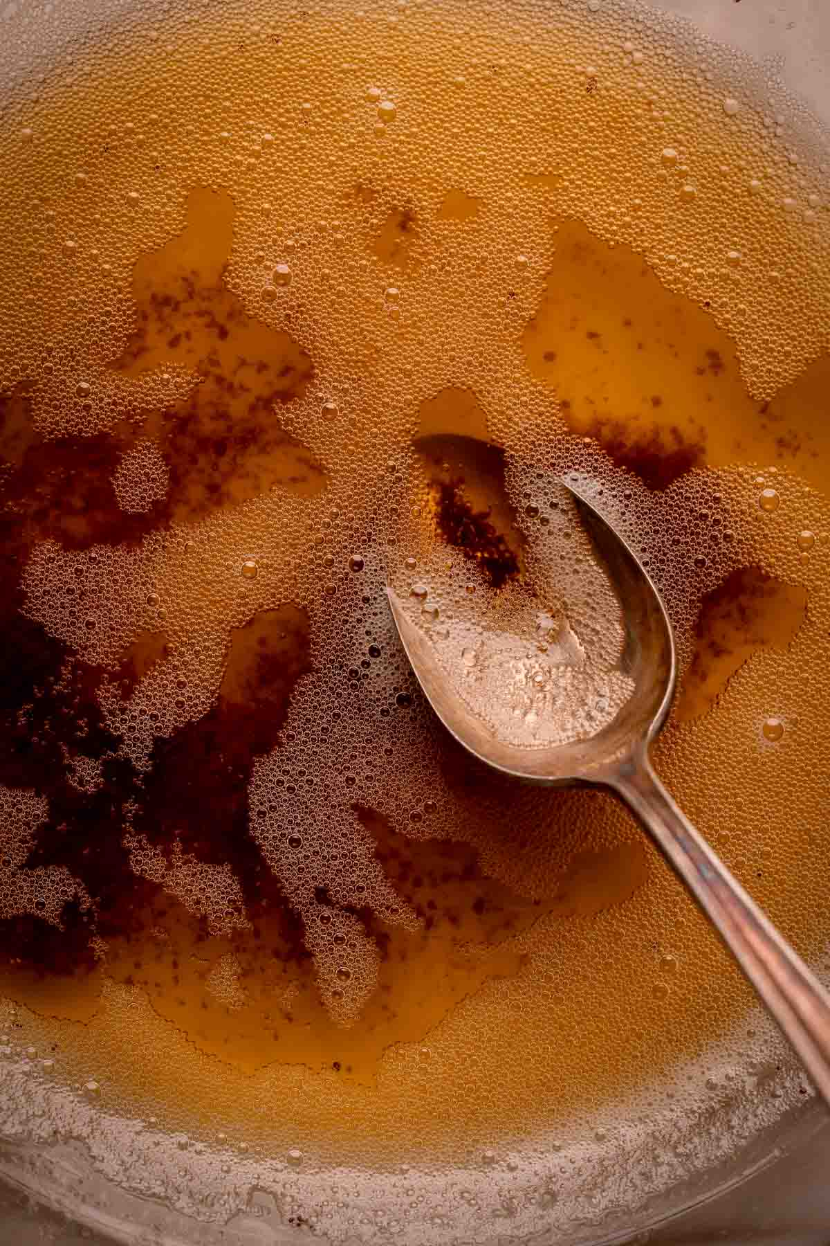 Brown butter in a bowl with a spoon.