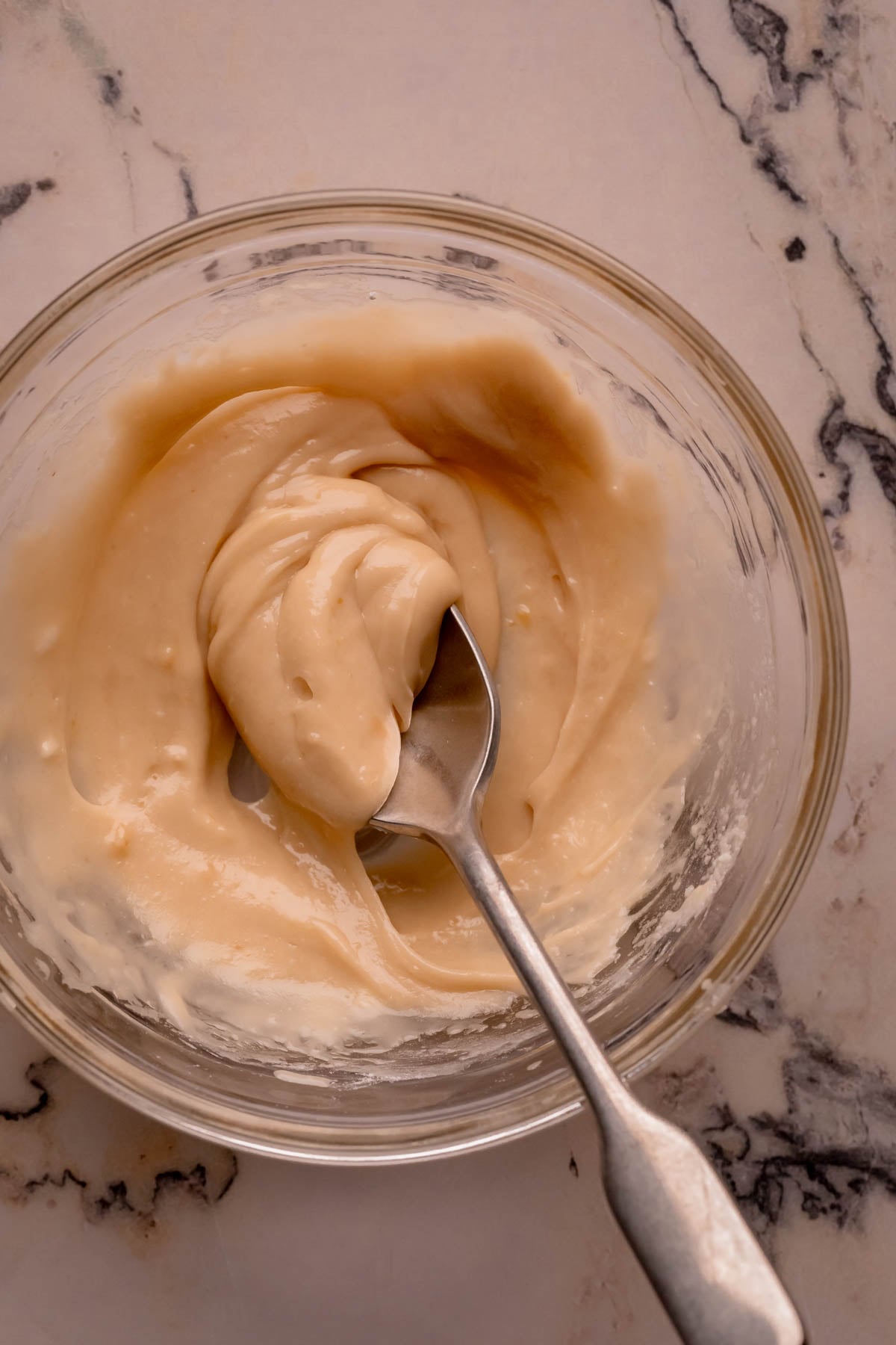 A bowl of miso maple glaze with a spoon.