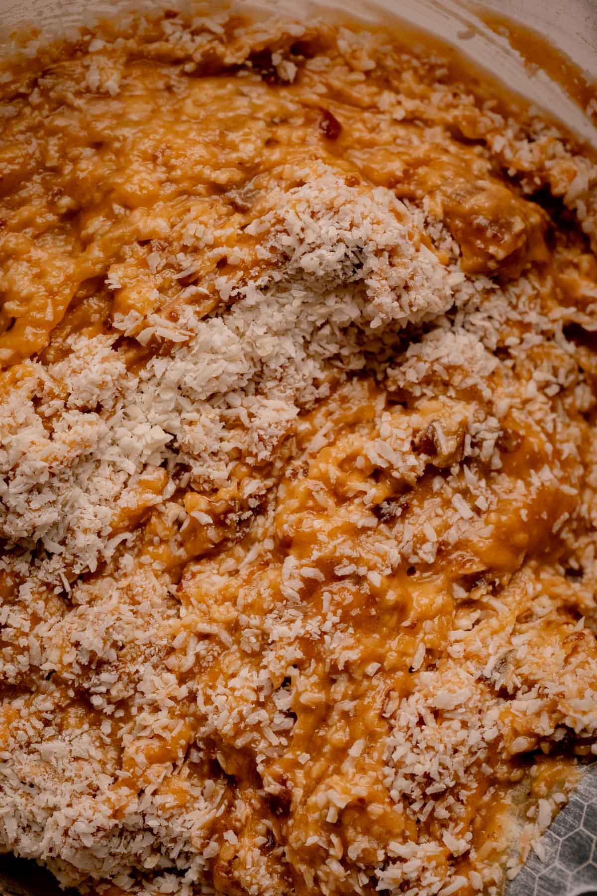 Shredded coconut folded into cake batter.