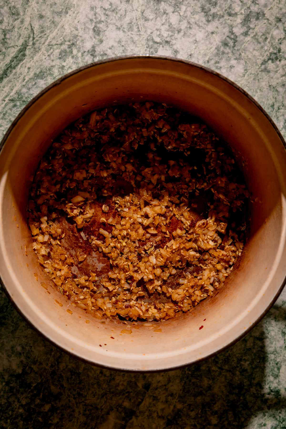 Sautéed onions, fennel seeds, and garlic in a dutch oven.