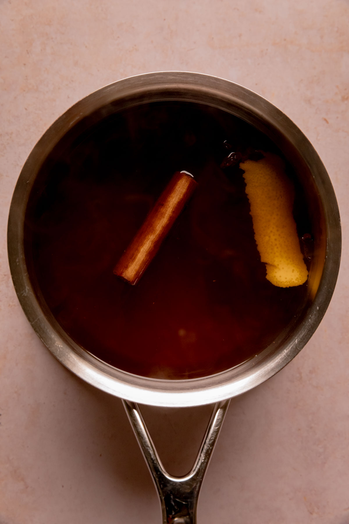 Sugar, spices, and water in a saucepan.
