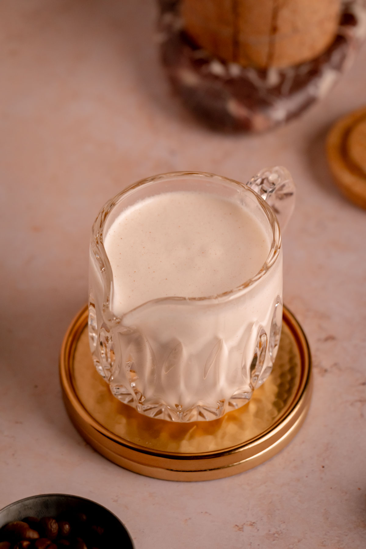 A carafe filled with cinnamon honey cold foam.