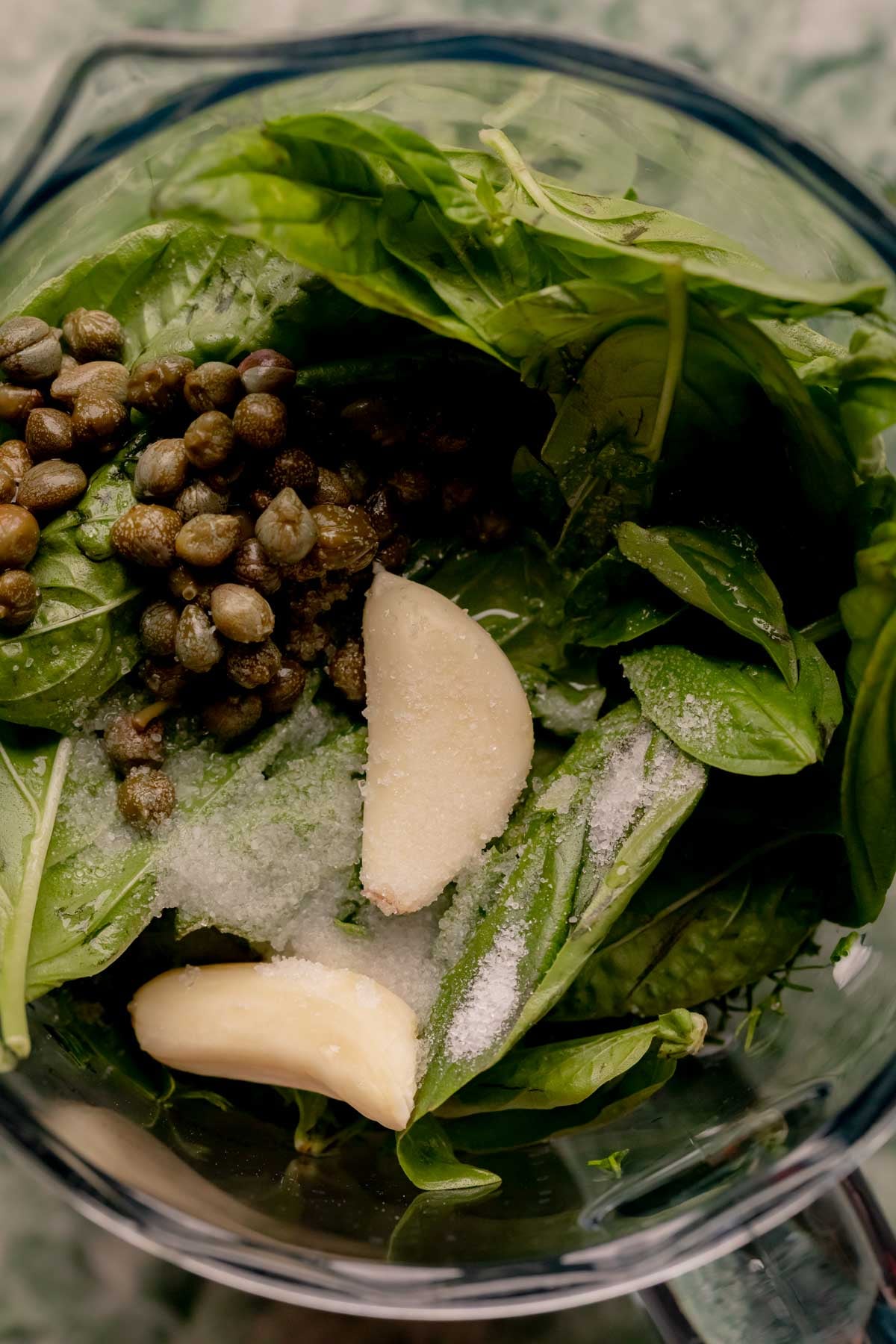 Ingredients for spicy green goddess sauce in a blender cup.