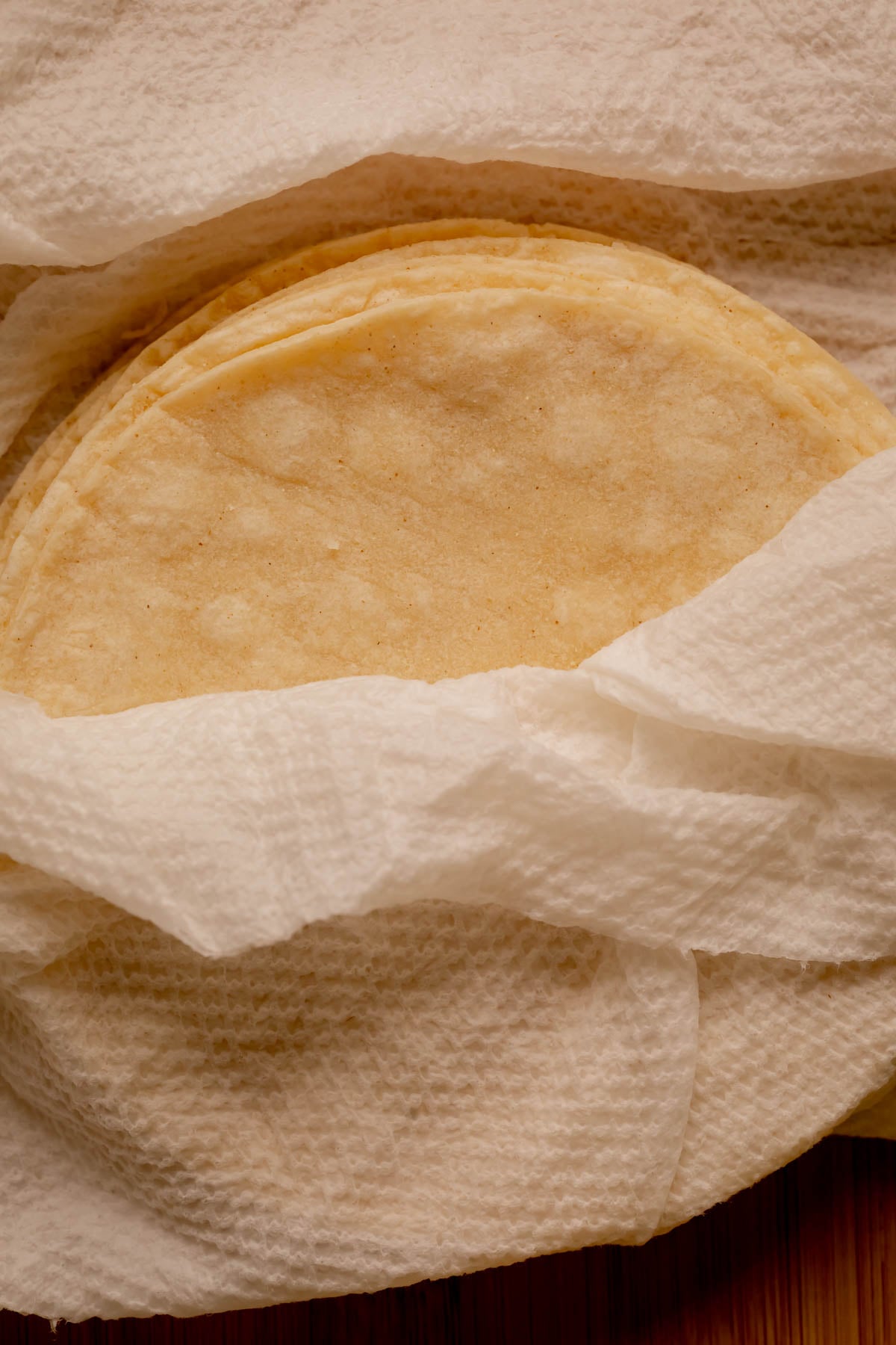 Tortillas wrapped in damp paper towels.